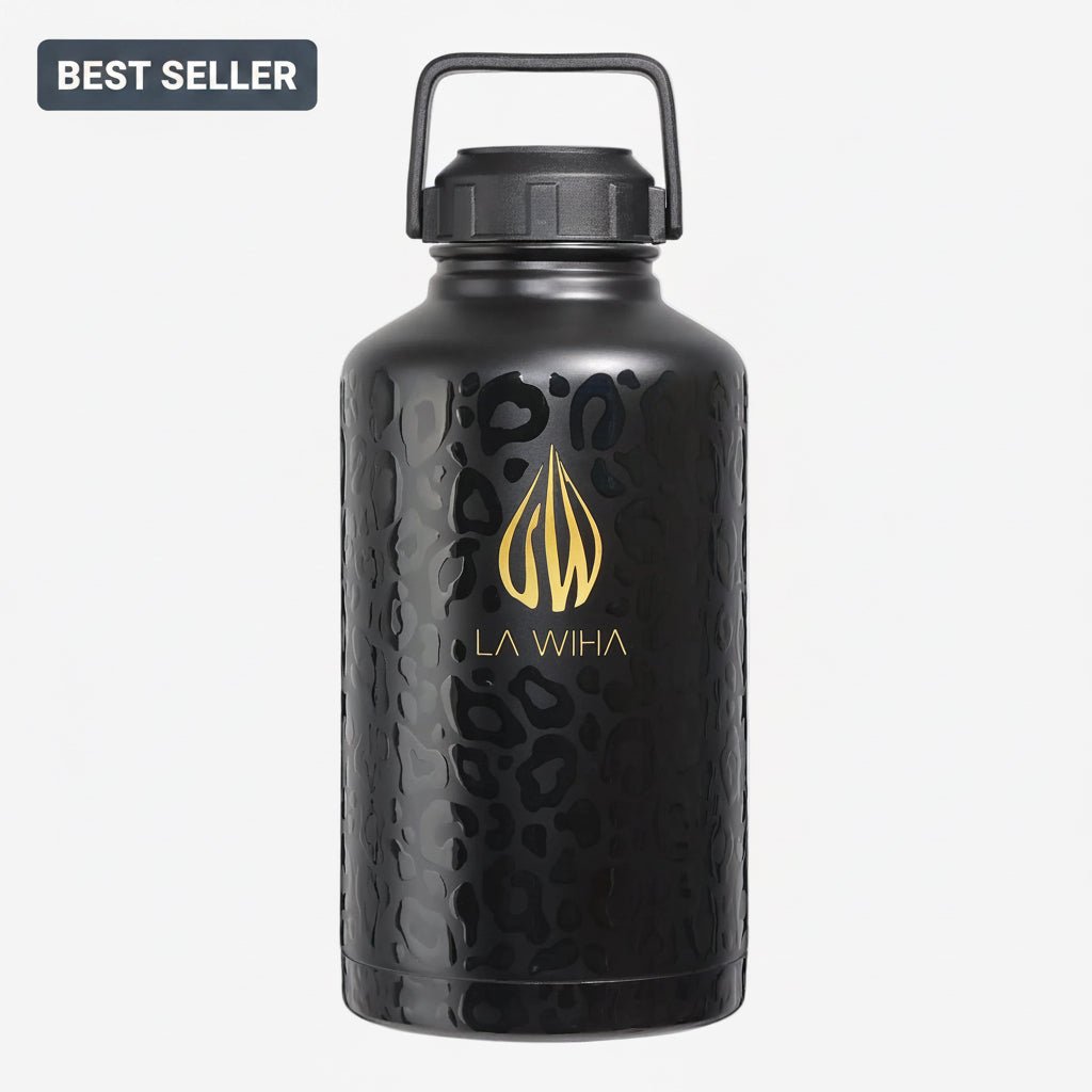 A 64 ounce half gallon matte black stainless steel insulated water jug with a textured leopard print pattern, featuring a gold La Wiha logo and name on the front. The bottle has a black handle carrying loop cap and is shown on a light gray background with a 'BEST SELLER' badge in the top-left corner.