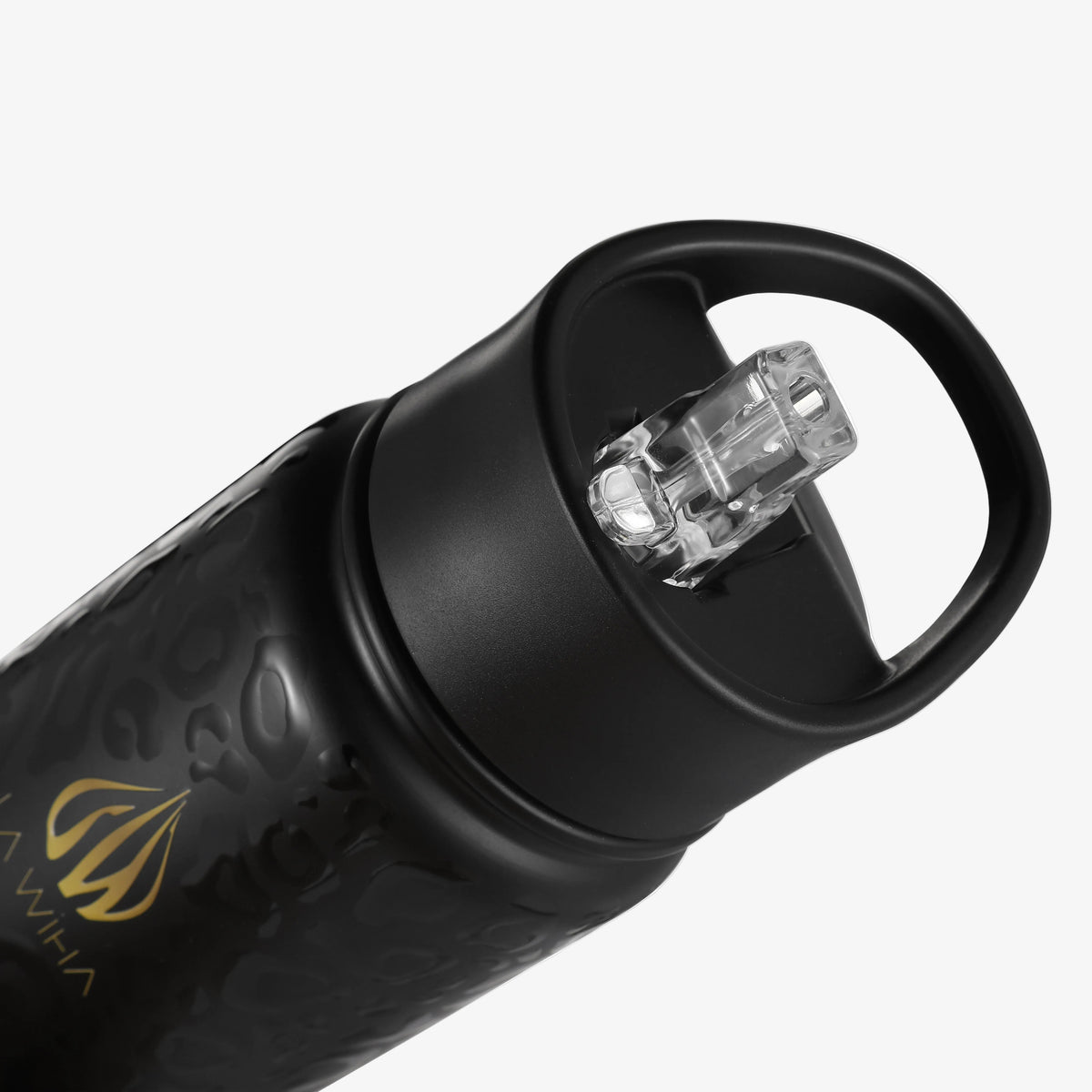 Close-up of a matte black water bottle with a clear flip-straw lid and a gold logo on a light gray background.