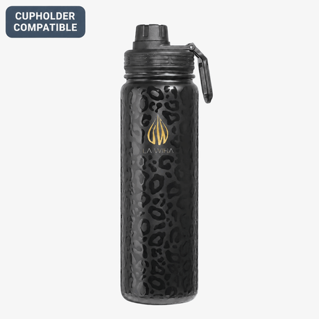 A light weight leopard print black La Wiha insulated 24 oz stainless steel water bottle with a textured leopard pattern, a gold logo, and a black sport spout lid with a carrying loop, shown on a white background with a 'Cupholder Compatible' badge
