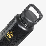 A close-up of a matte black water bottle with a subtle leopard pattern, featuring a gold 'LA WIHA' logo. The bottle is shown at an angle with its carabiner clip lid closed position